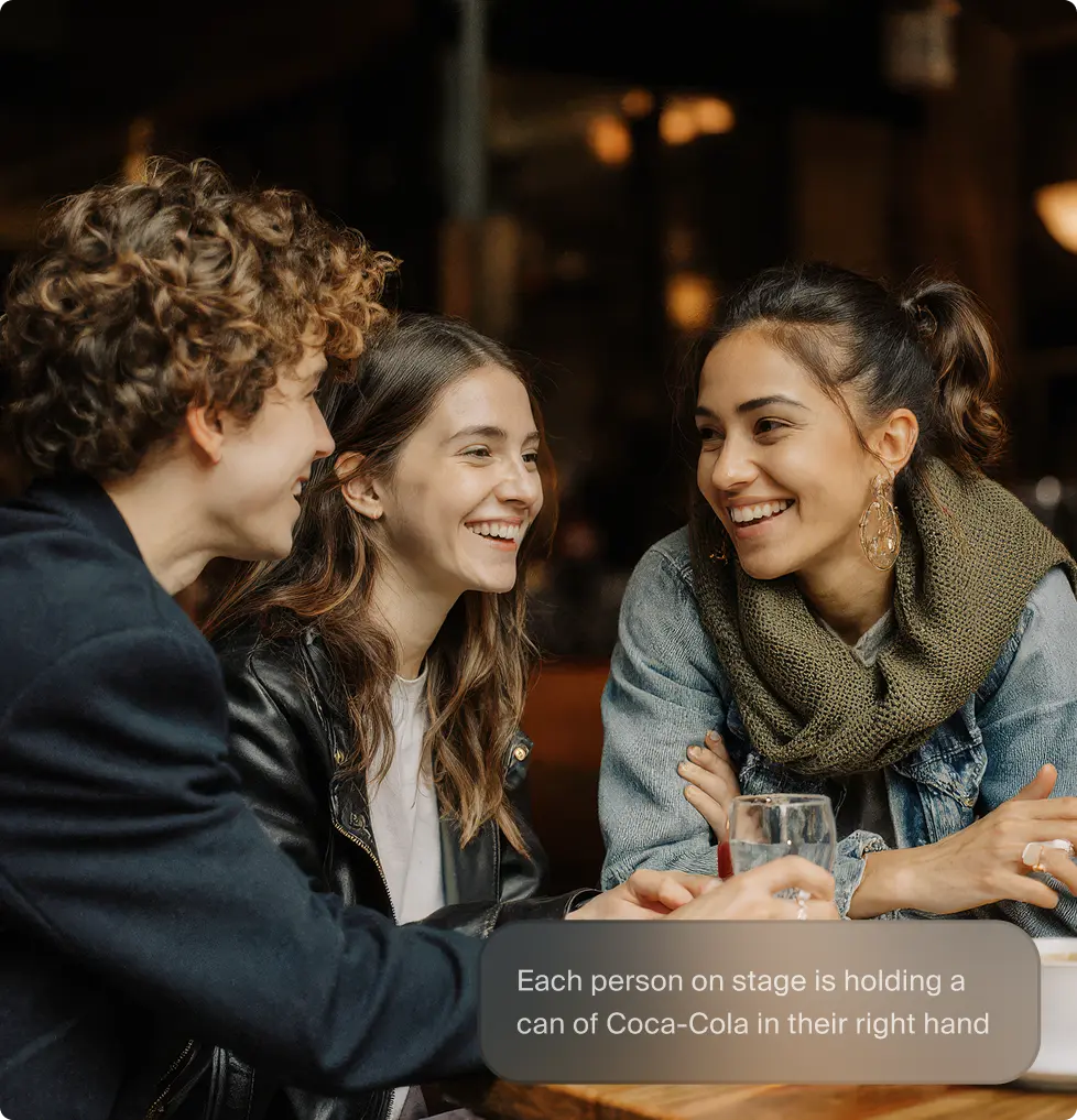 A pixelated image of an orange and white cat lying down, looking to the side, with blurred greenery in the background